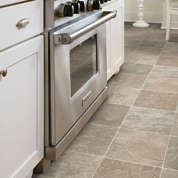 a kitchen with stainless steel appliances and white cabinets