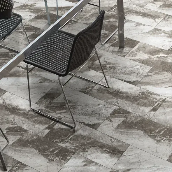 A dining area with a patterned tile floor and metal chairs under a table.
