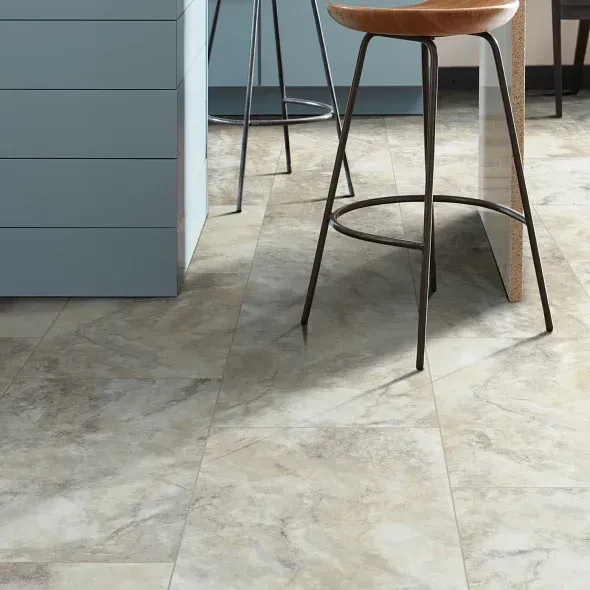 Marble-look flooring with a stool in a kitchen setting; pale brown and gray colors.