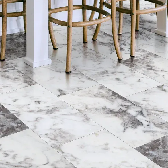 Marble-look flooring with white and gray veining. Wooden chair legs and table leg in view.