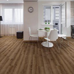 Dining room with brown wood-look flooring, white table and chairs, and a window.