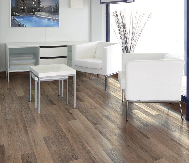 Modern living room with white furniture, wood floor, and a pool picture.