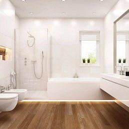 Modern white bathroom with wood floor, bathtub, shower, toilet, and window.