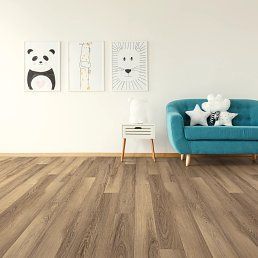 Room with light wooden floor, teal couch, and animal art. A white bedside table sits in front of the wall.