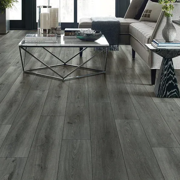 Gray wood-look flooring in a modern living room setting with a sectional sofa, coffee table, and side table.