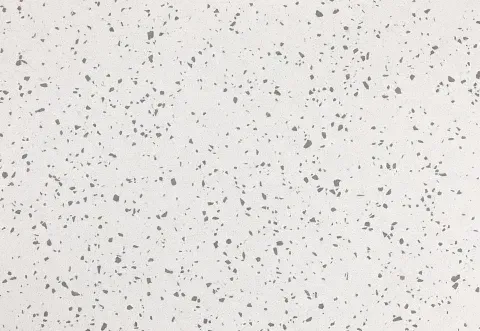 White surface with gray flecks scattered across it.