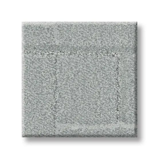 Gray square carpet sample with a textured surface and lighter bordering pattern.