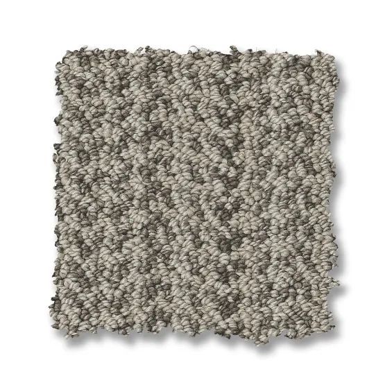 Neutral-colored, textured carpet sample with varying shades of gray and beige.