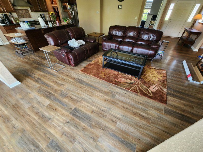 a living room with a couch , chair , coffee table and rug .