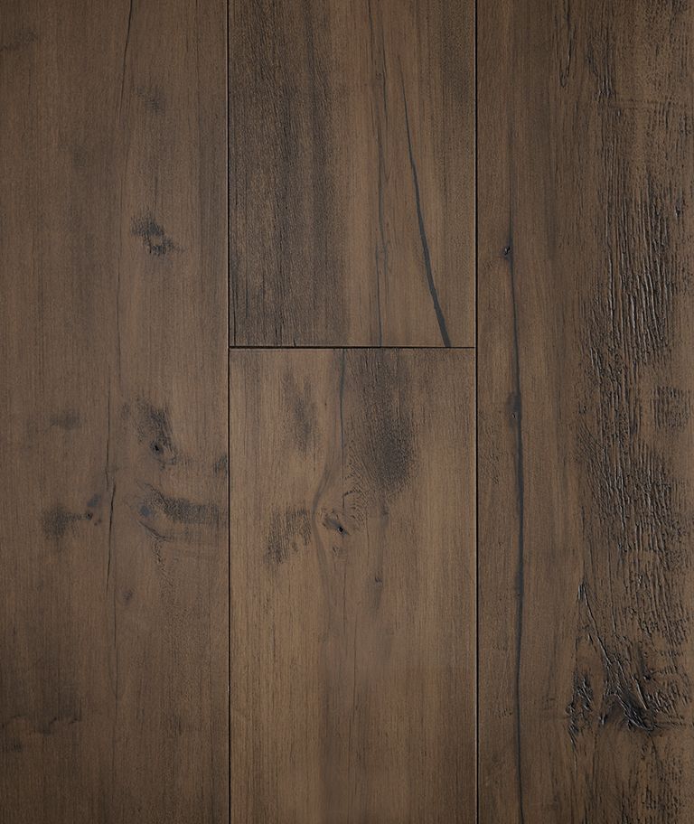 Close-up of weathered, gray-brown wood flooring with visible grain and knots.