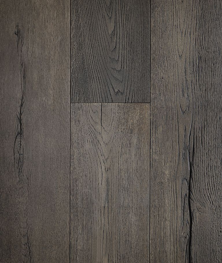 Dark, weathered wood flooring with visible grain and knots, varying shades of gray and brown.