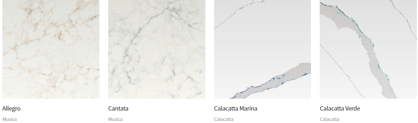 Four different marble-patterned stone samples; cream, white with thin grey veins, and white with thick grey veins.