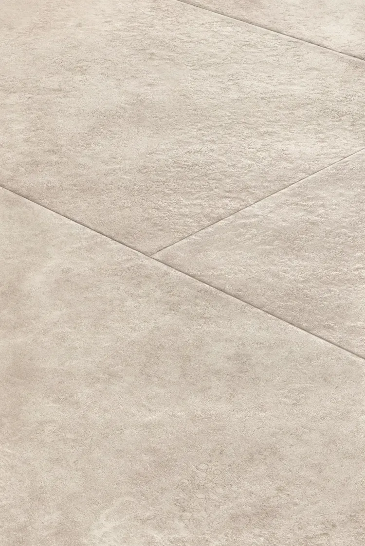 Close-up of light beige textured flooring with visible seams.