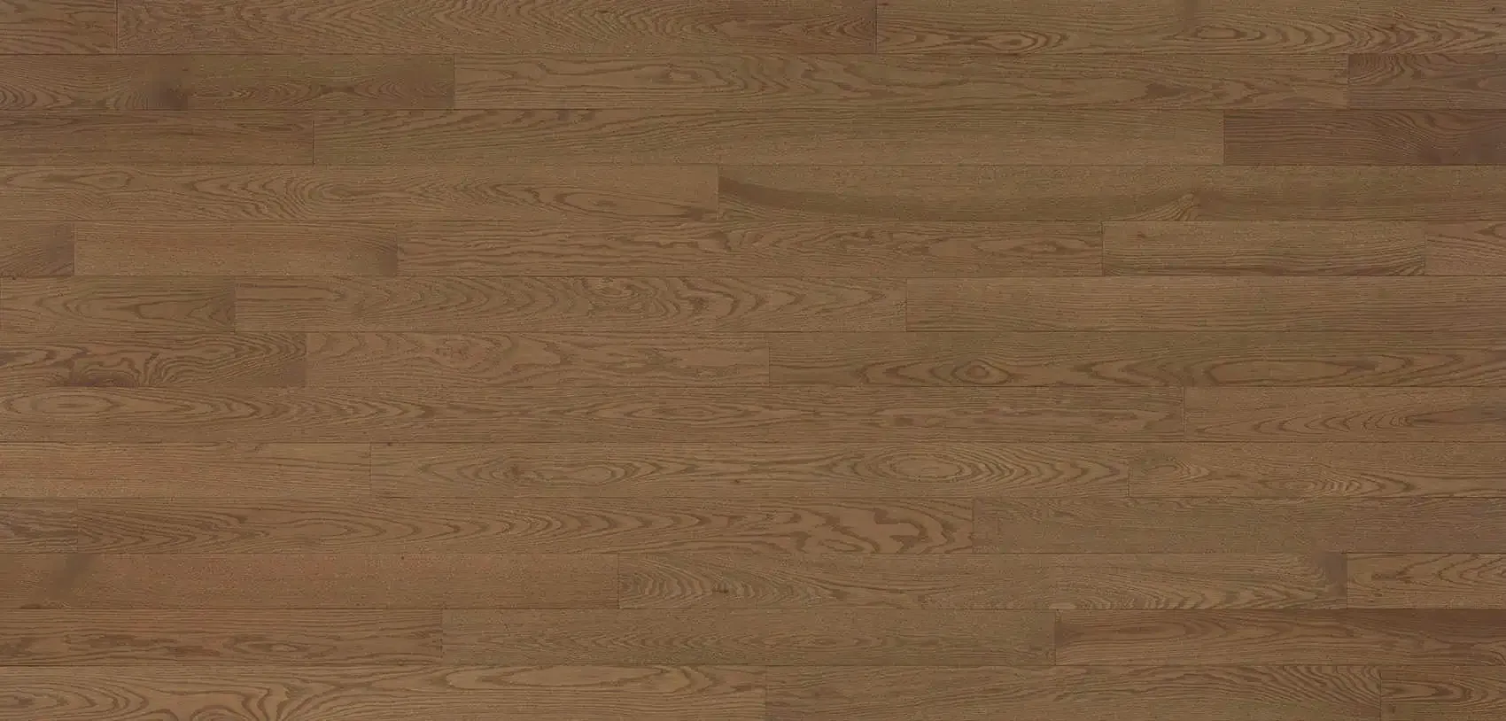 Close-up of a light brown hardwood floor with horizontal planks.