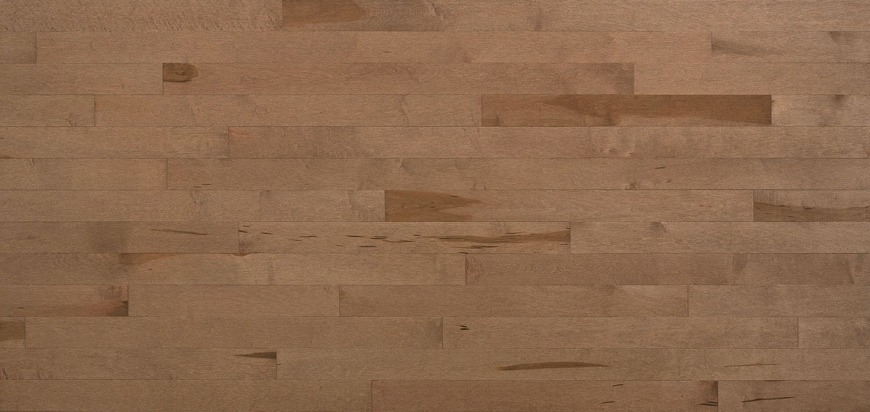 Close-up of light brown wood flooring, with a textured surface and rectangular panels.