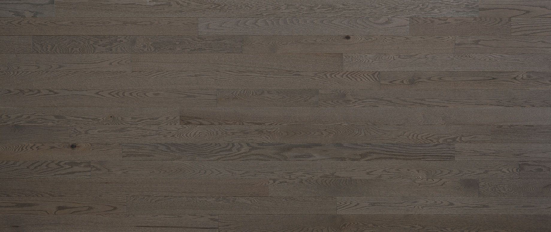 Close-up of dark-toned wooden floorboards with visible grain and horizontal lines.
