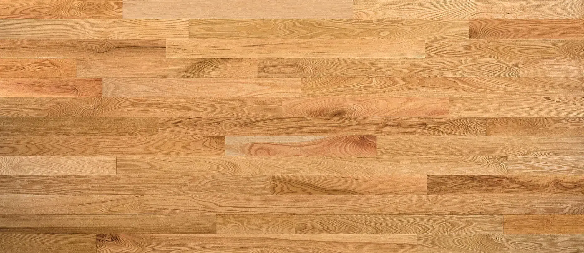 Wooden hardwood flooring in a light tan color with horizontal planks.