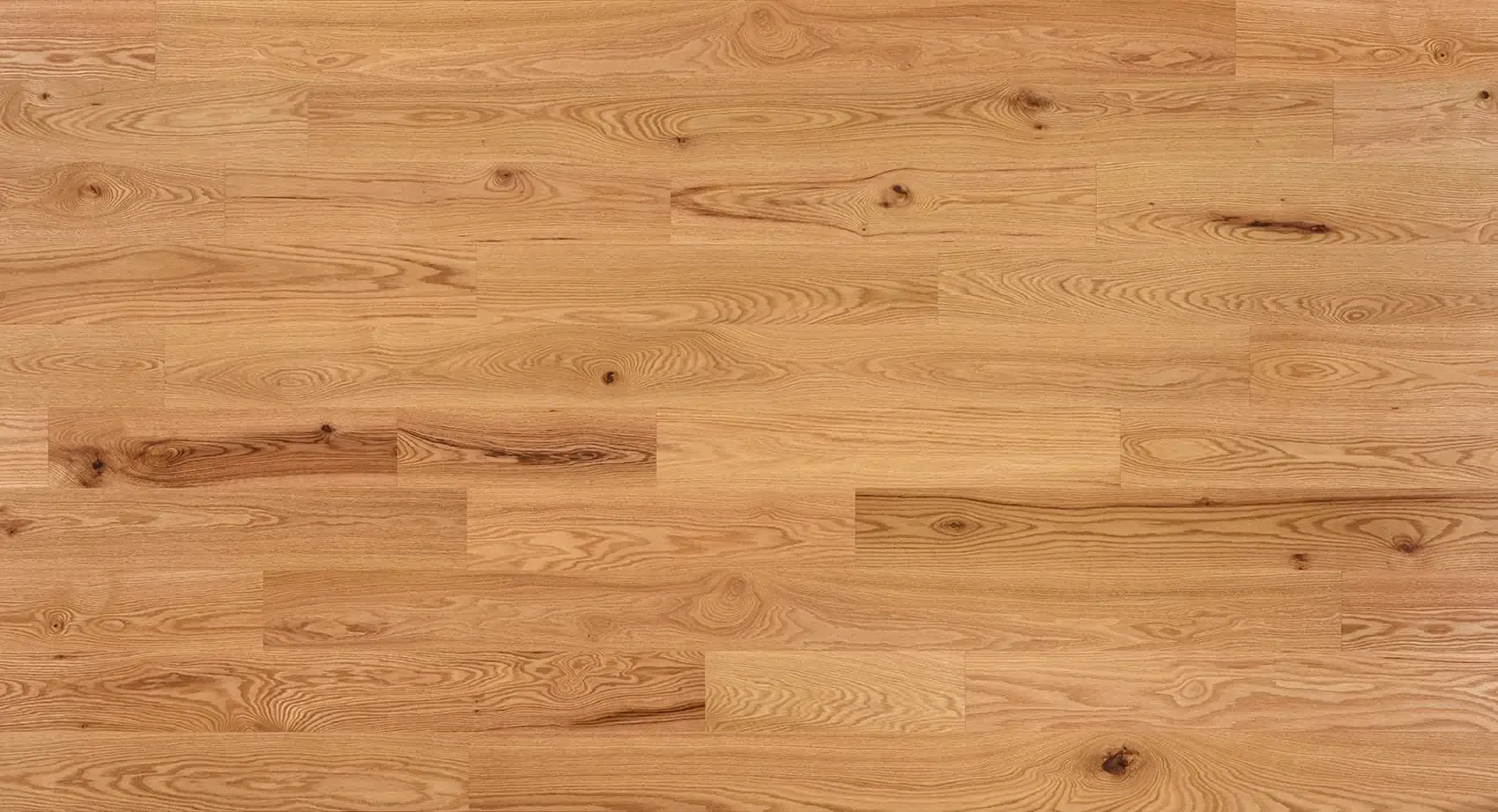 Wooden butcher block countertop with light brown tones and wood grain.