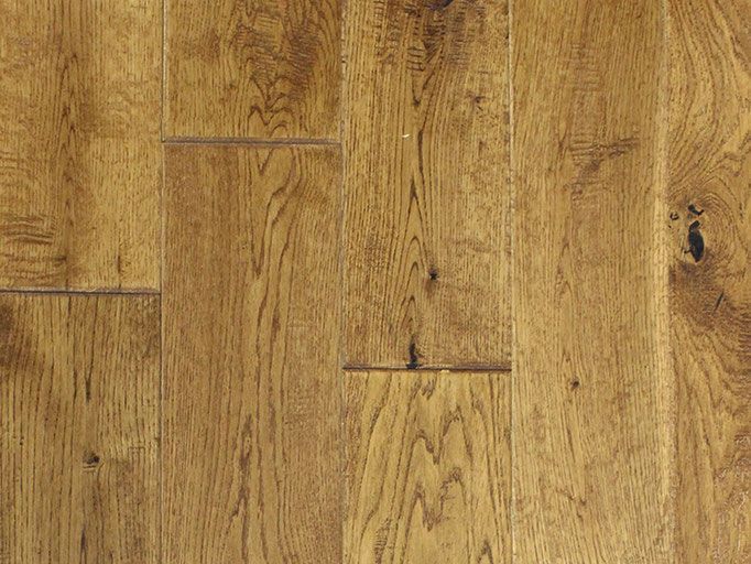 Close-up of hardwood flooring with natural wood grain patterns in warm brown tones.