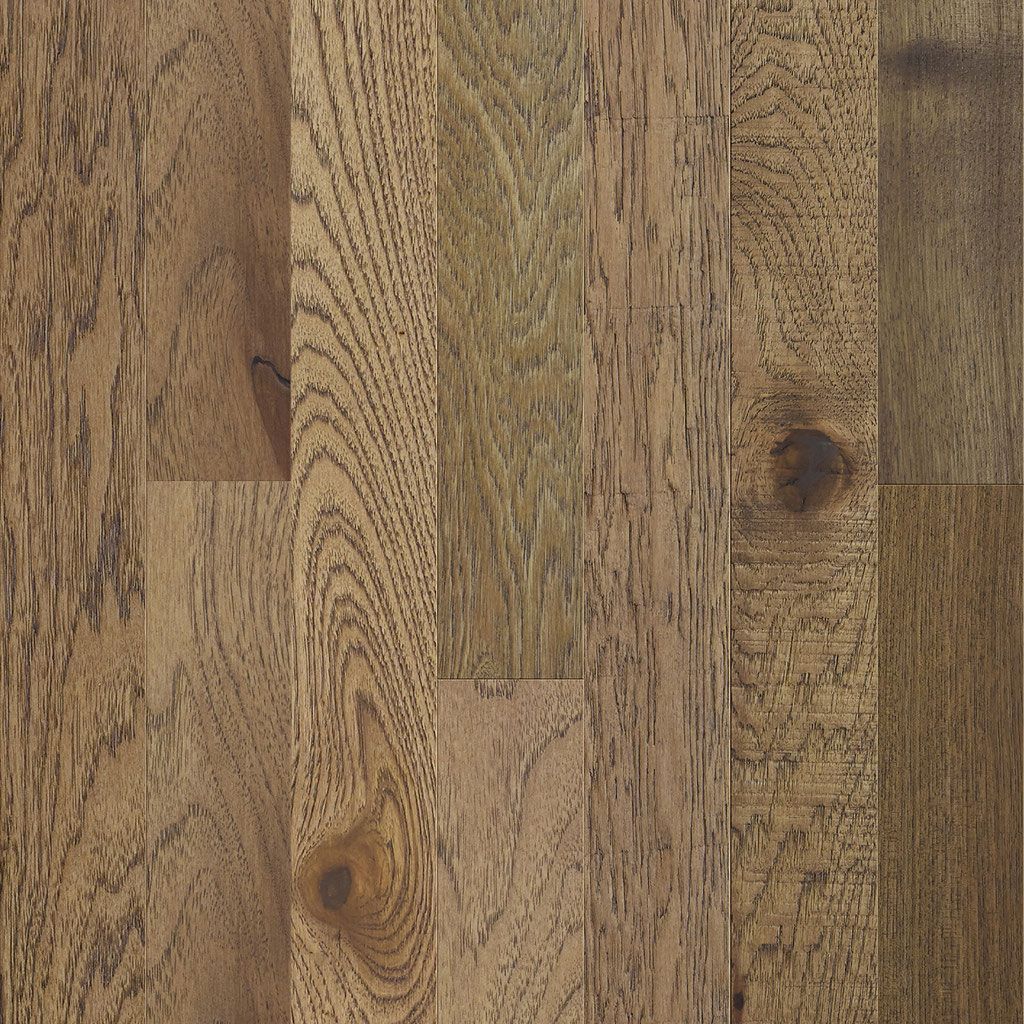 Close-up of hardwood floor planks in shades of brown and tan with wood grain.