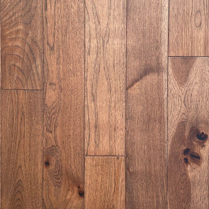 Close-up of wood flooring; brown and tan colors with natural grain and knots.