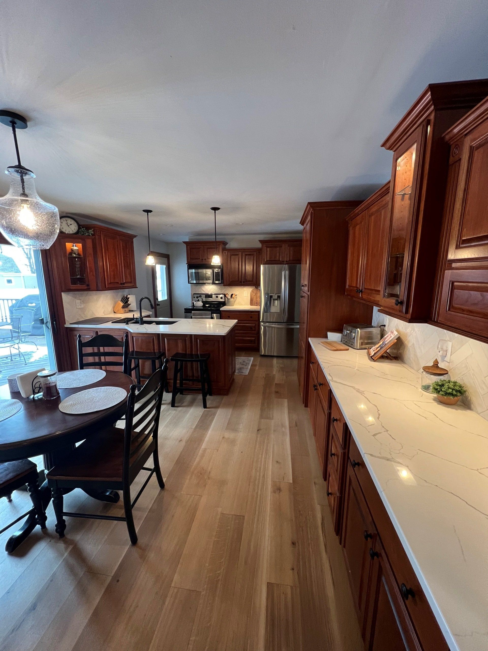 A kitchen with wooden cabinets and white counter tops