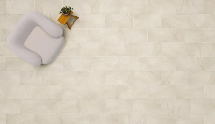 Overhead view of a cream-colored tiled floor with a white armchair and small plant table.