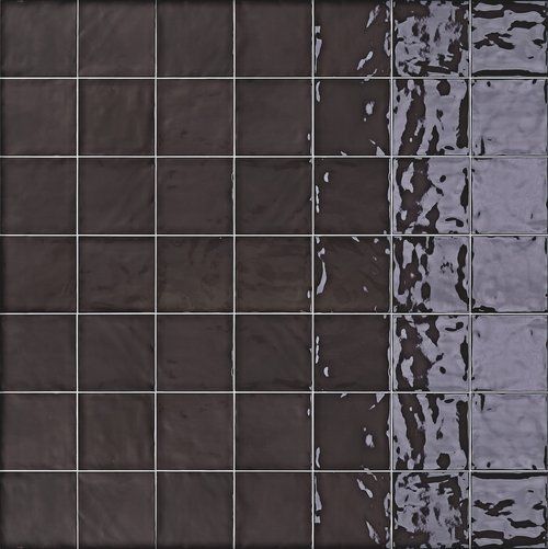 Dark square ceramic tiles, fading to a shiny, light-toned gray. Silver grout lines.