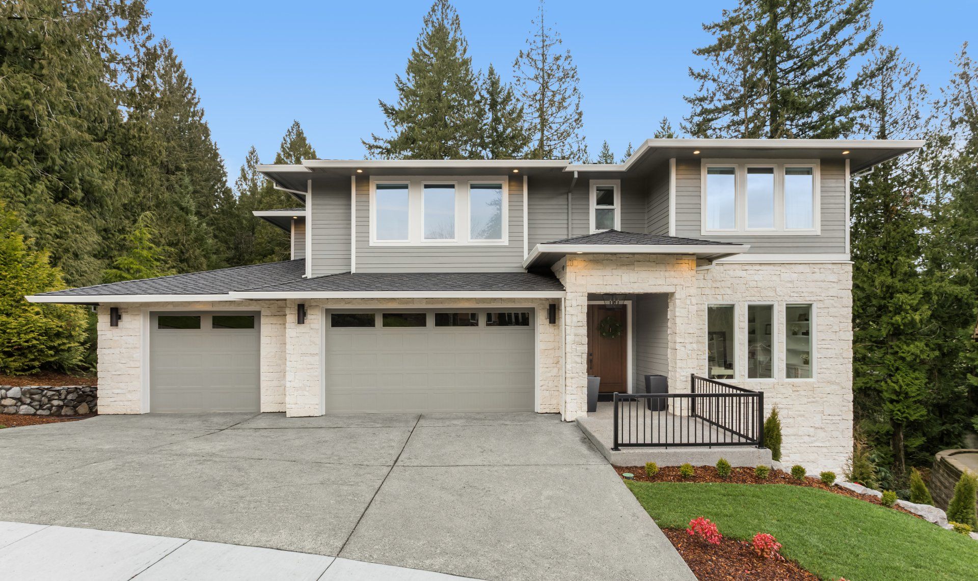A large house with a lot of windows and trees in the background.