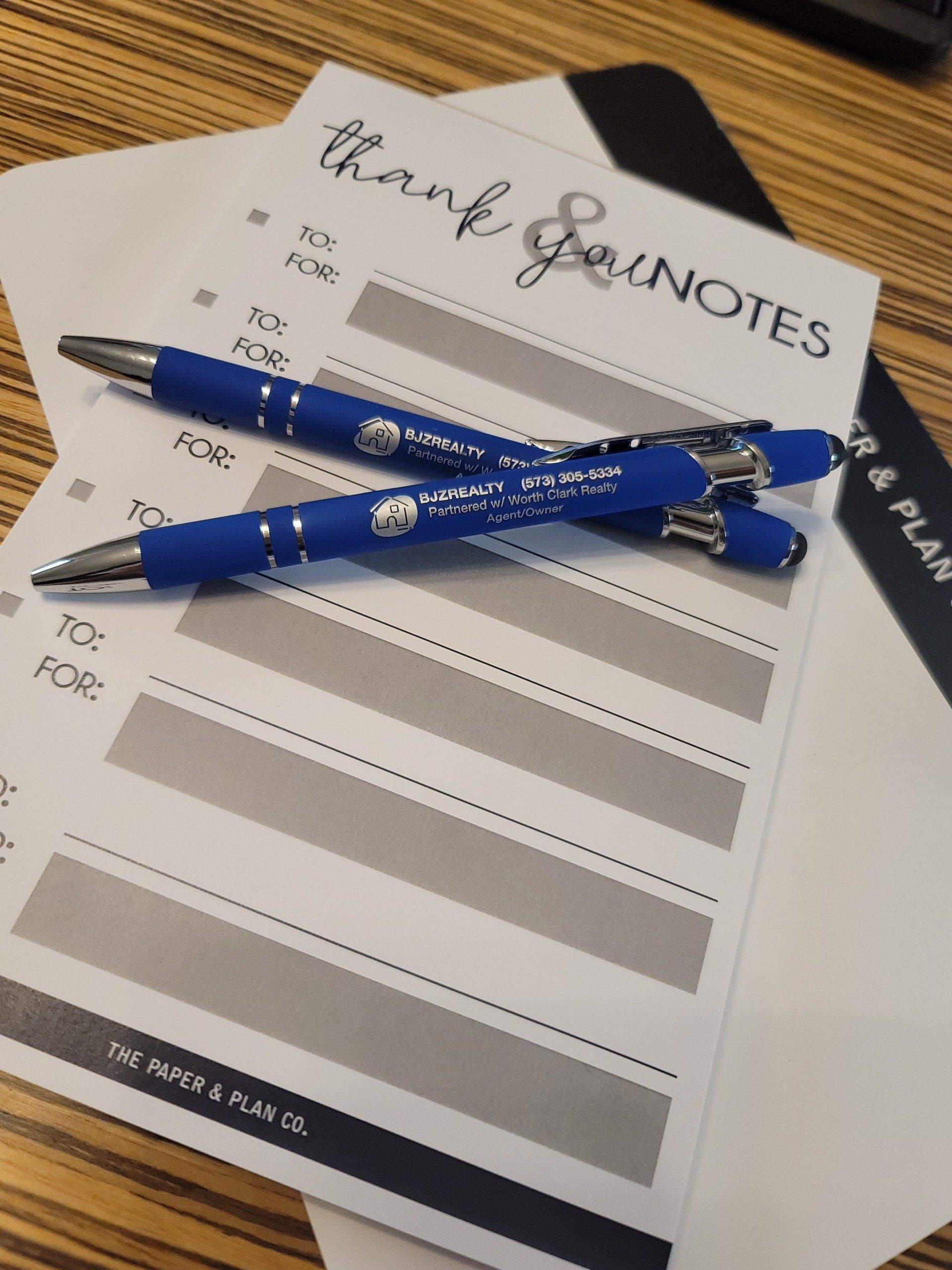 Two pens are sitting on top of a piece of paper that says thank you notes