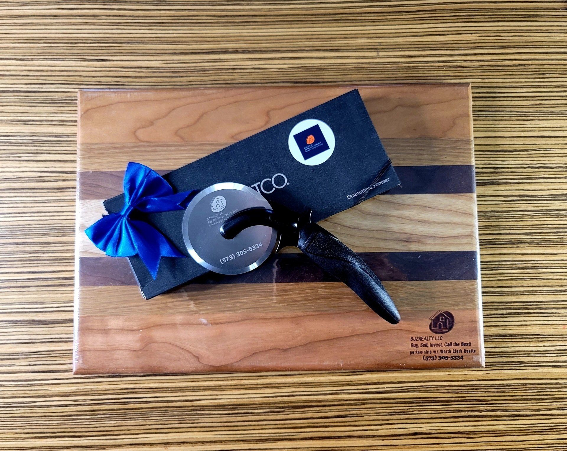 A pizza cutter is sitting on top of a wooden cutting board.