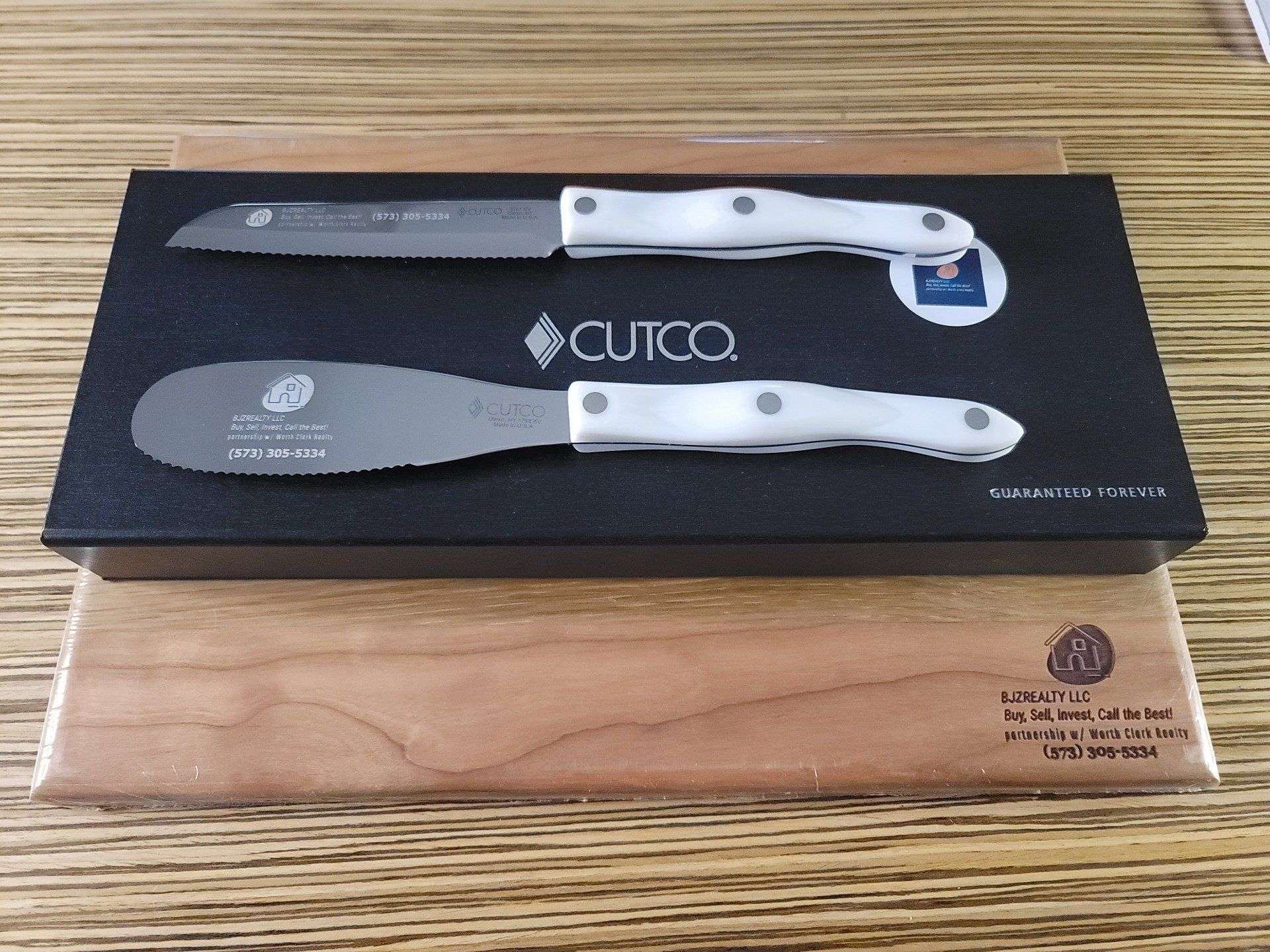 A cutting board with two knives and a spatula on it