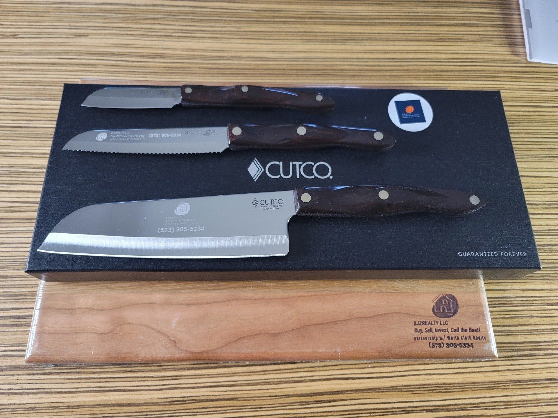 A set of three knives in a box with the word cutco on it
