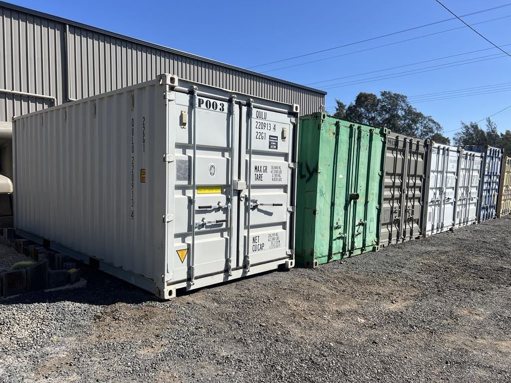 A Row of Shipping Containers Are Parked in Front of a Building — Toowoomba Container Hire & Sales in Gatton, QLD
