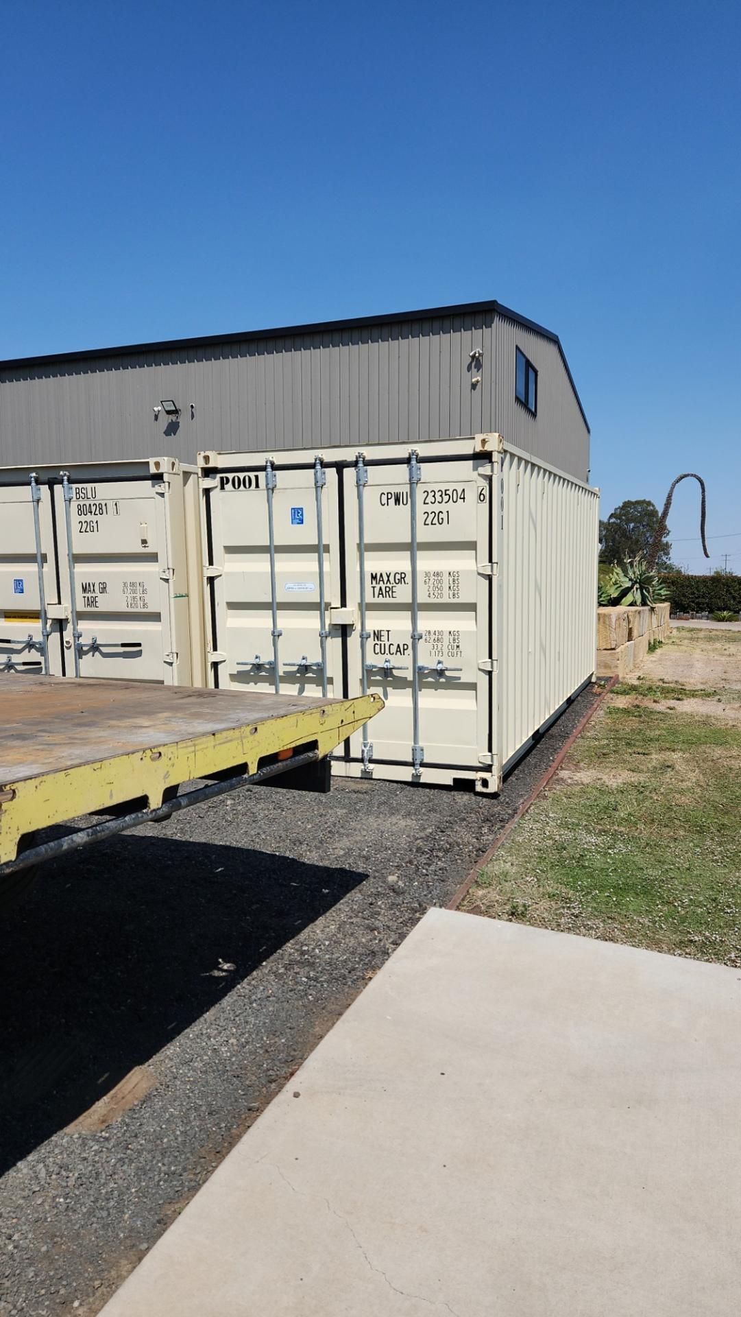 A White Shipping Container is Parked in Front of a Building — Toowoomba Container Hire & Sales in Highfields, QLD