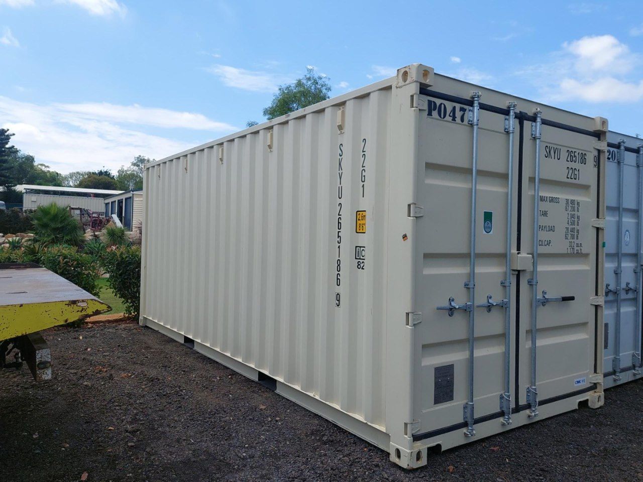 A Large White Shipping Container is Parked in a Gravel Lot — Toowoomba Container Hire & Sales in Wilsonton, QLD