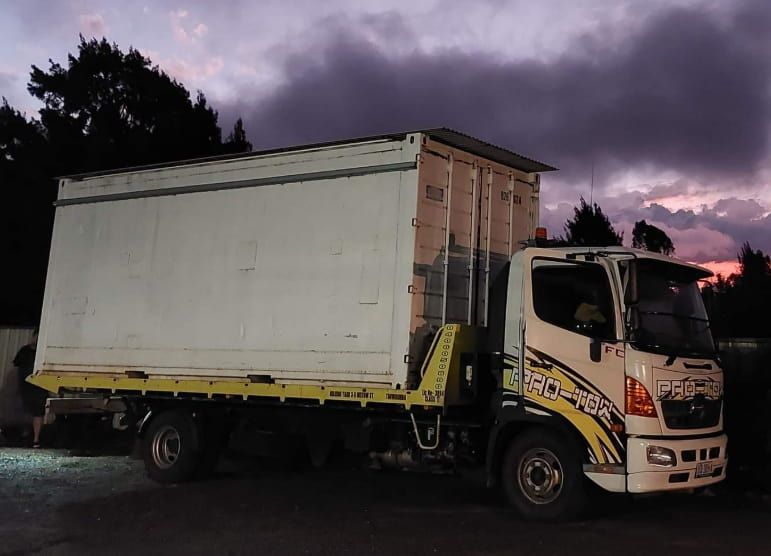 A White Truck With a Yellow Crane on the Back is Parked — Toowoomba Container Hire & Sales in Oakey, QLD