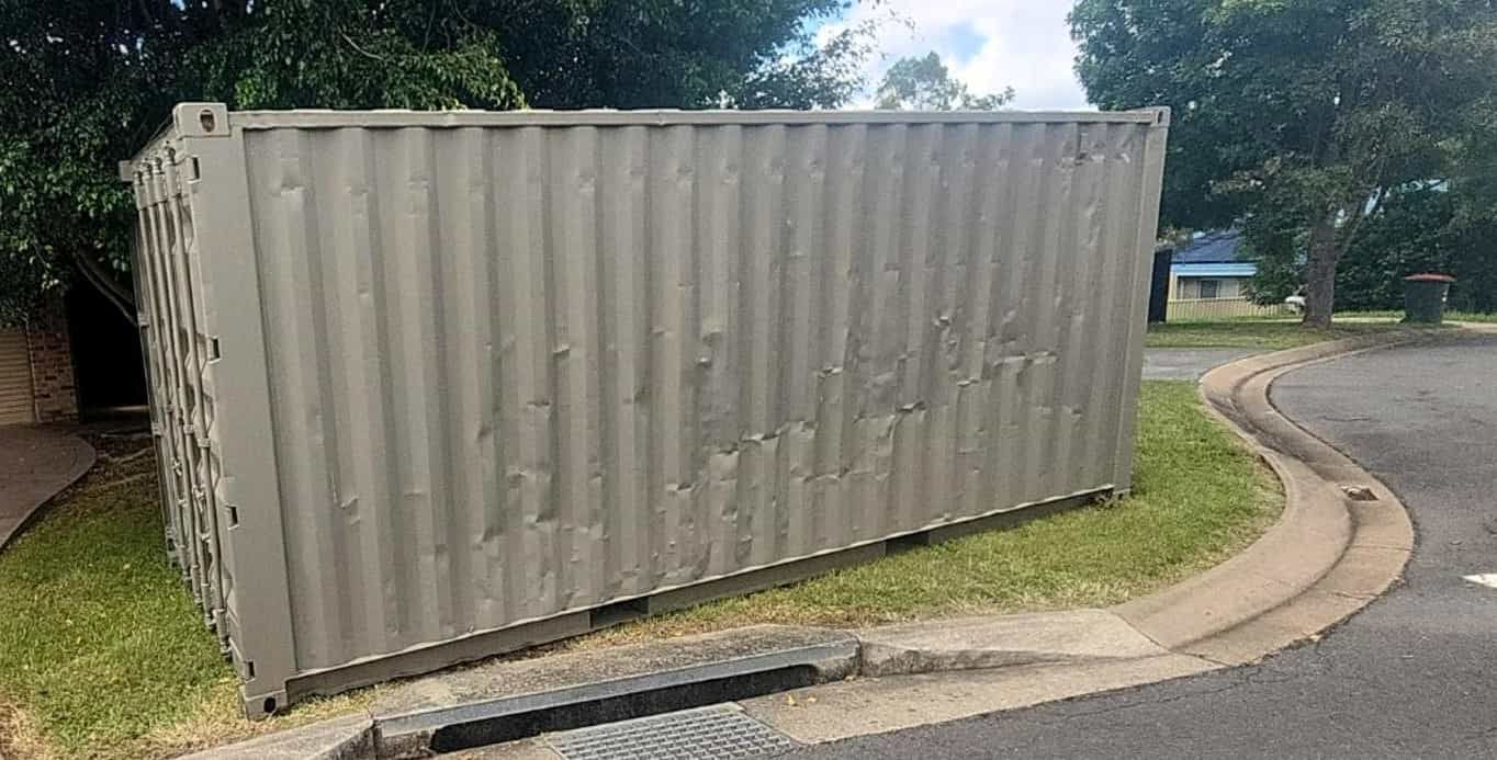 A Shipping Container is Sitting on the Side of the Road Next to a Curb — Toowoomba Container Hire & Sales in Warwick, QLD