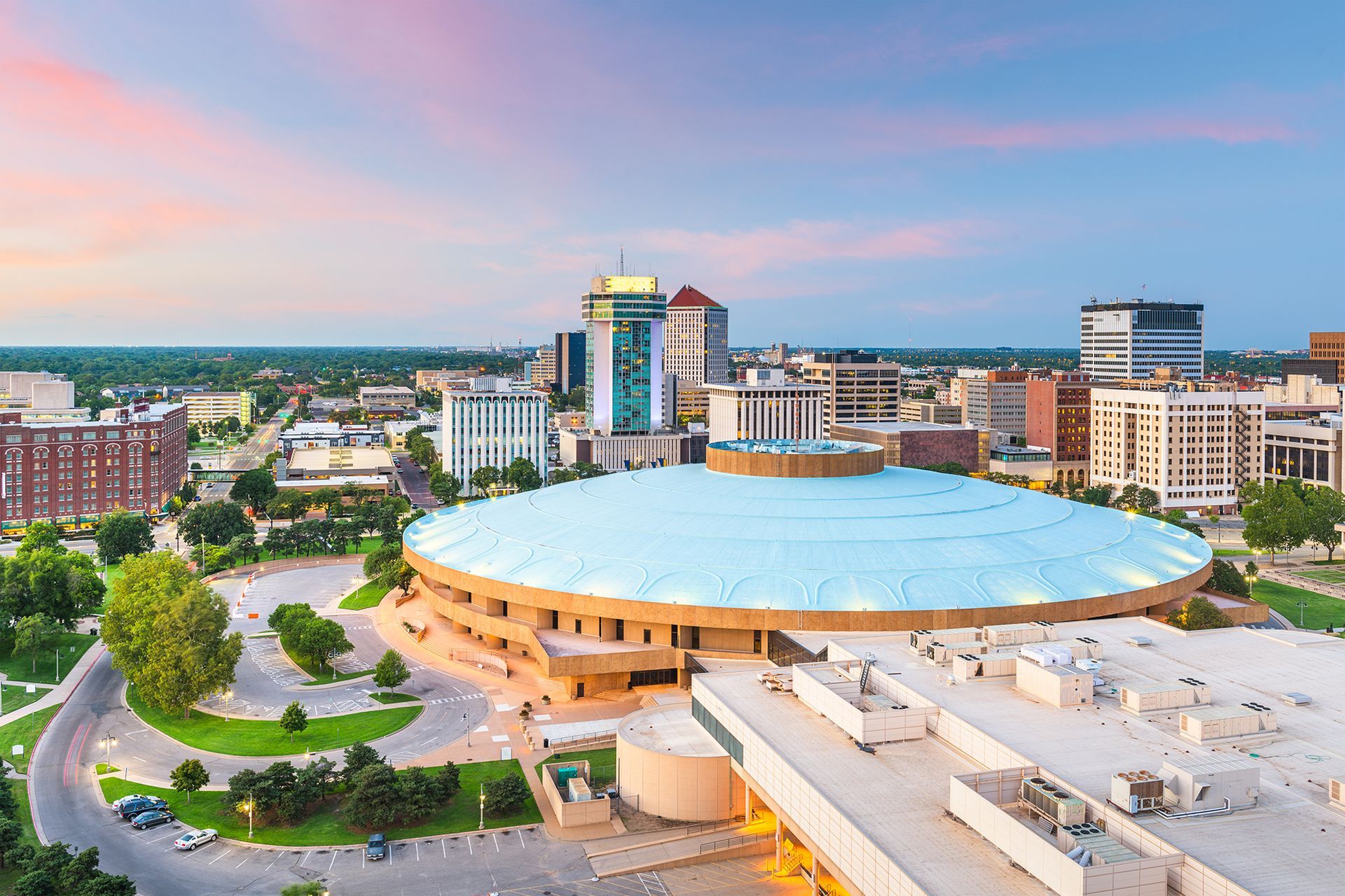 An aerial view of a city with a large dome in the middle of it.