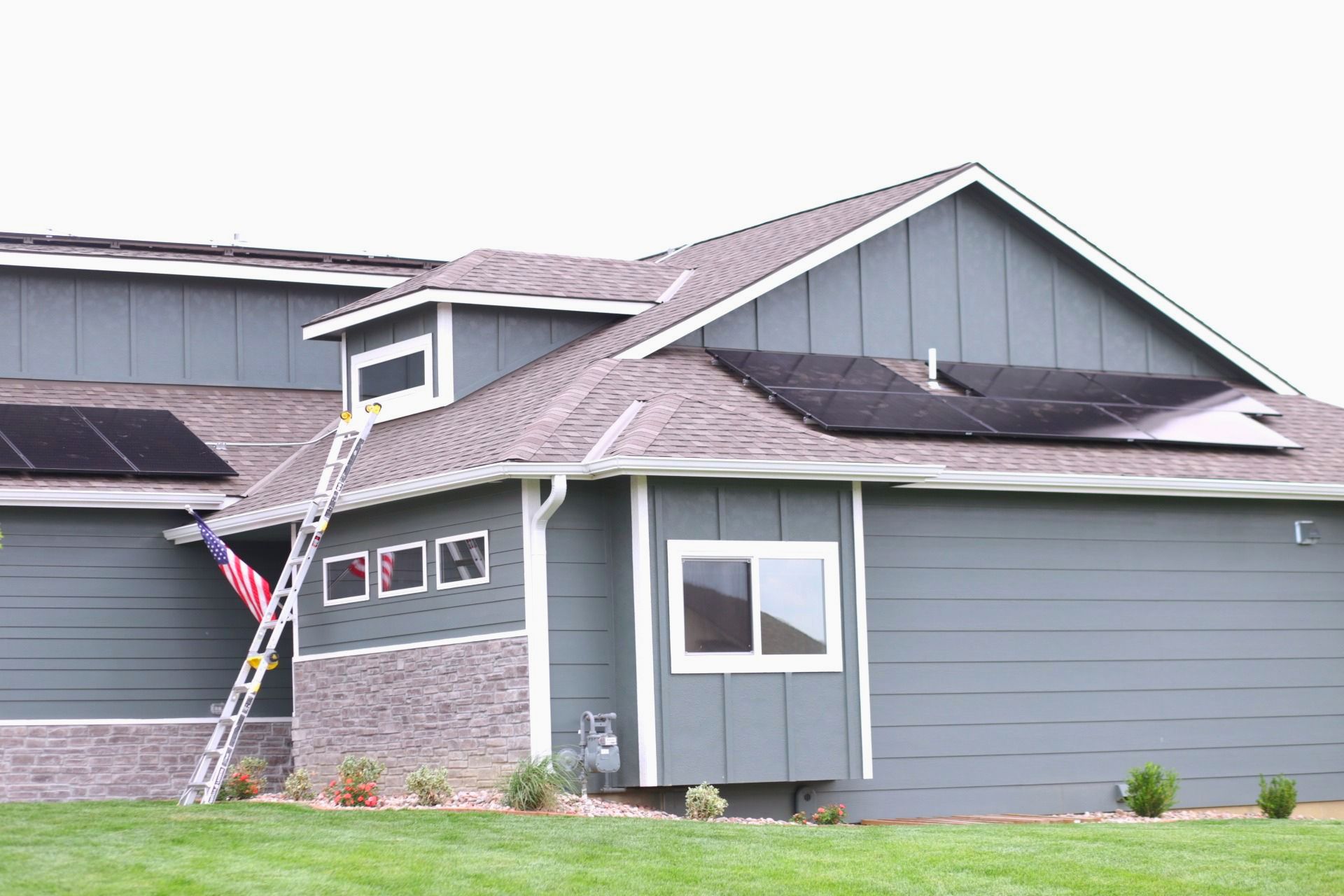 A man and woman are carrying two children on their shoulders.