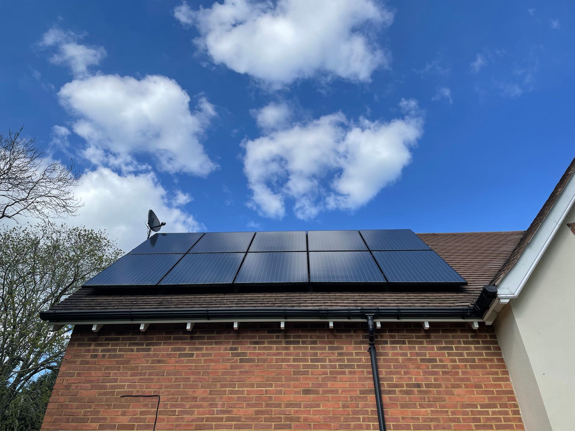 A brick building with solar panels on the roof.