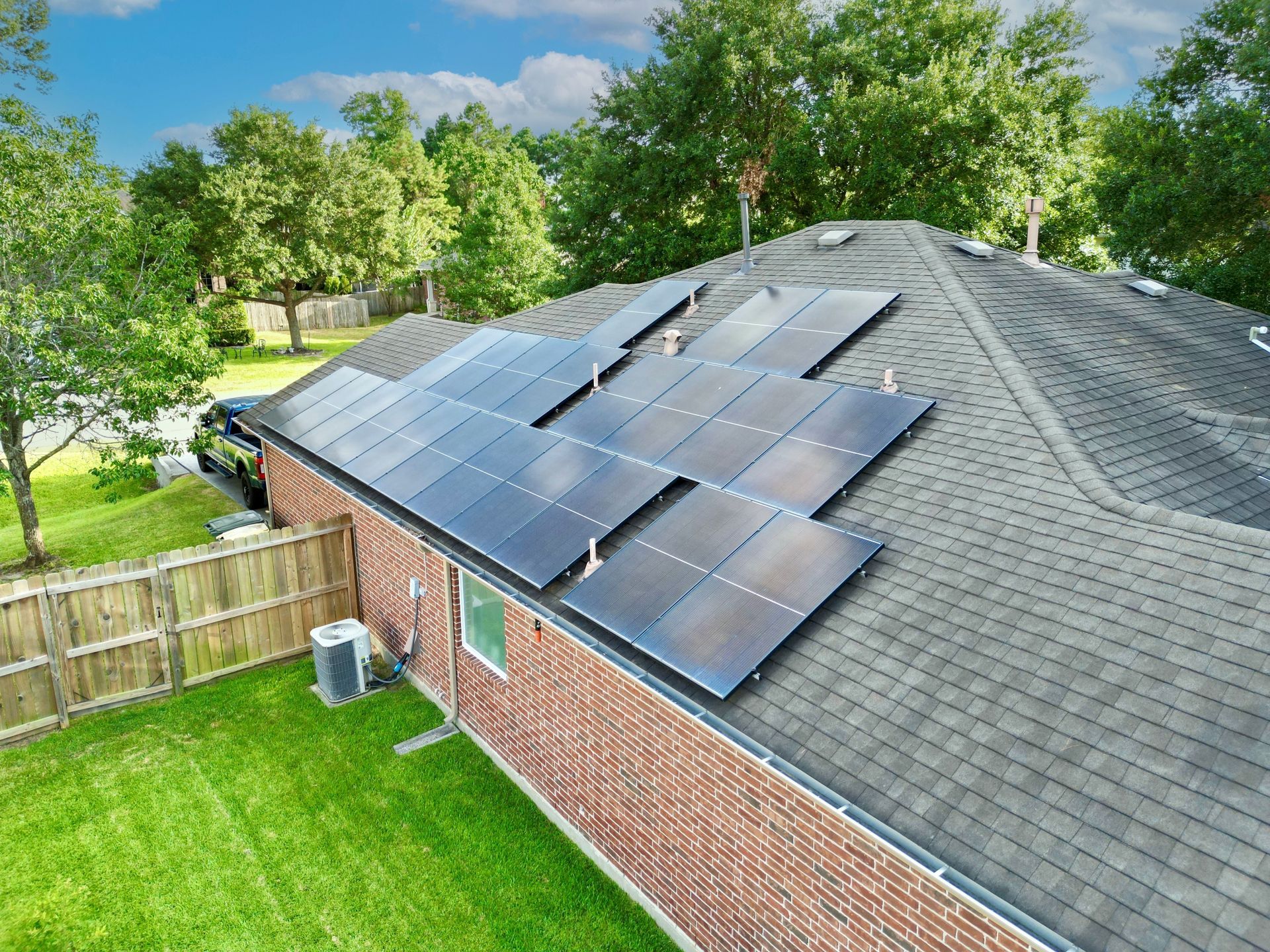 A brick house with solar panels on the roof.