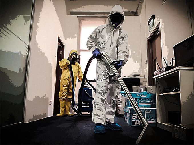 man wearing bio hazard suit and gas mask using industrial vacum