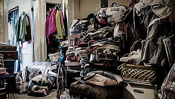 living room with high piles of clothes and rubbish