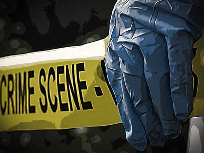 person wearing blue rubber gloves holding yellow crime scene tape
