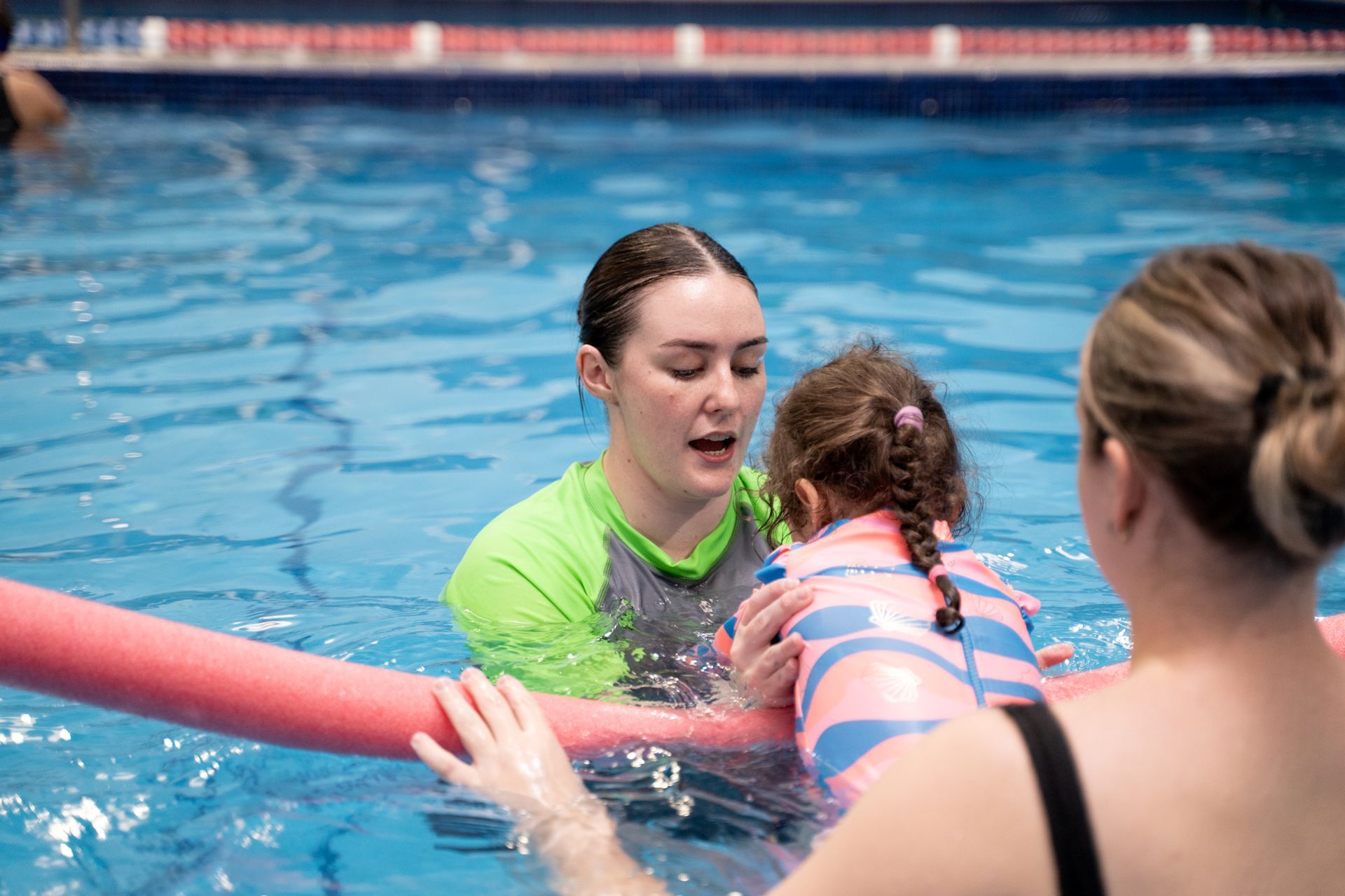 Toddler smiling in the pool doing hydrotherapy 