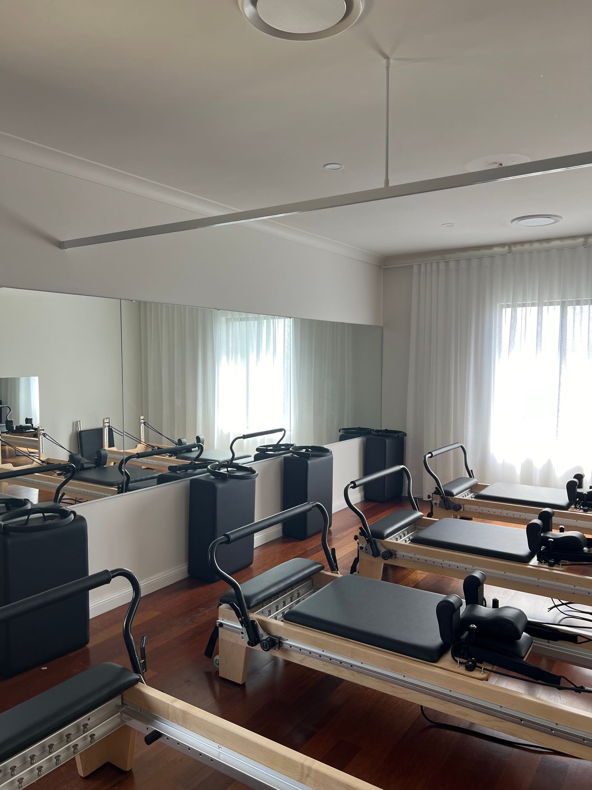 There are a lot of pilates machines in this treatment room.