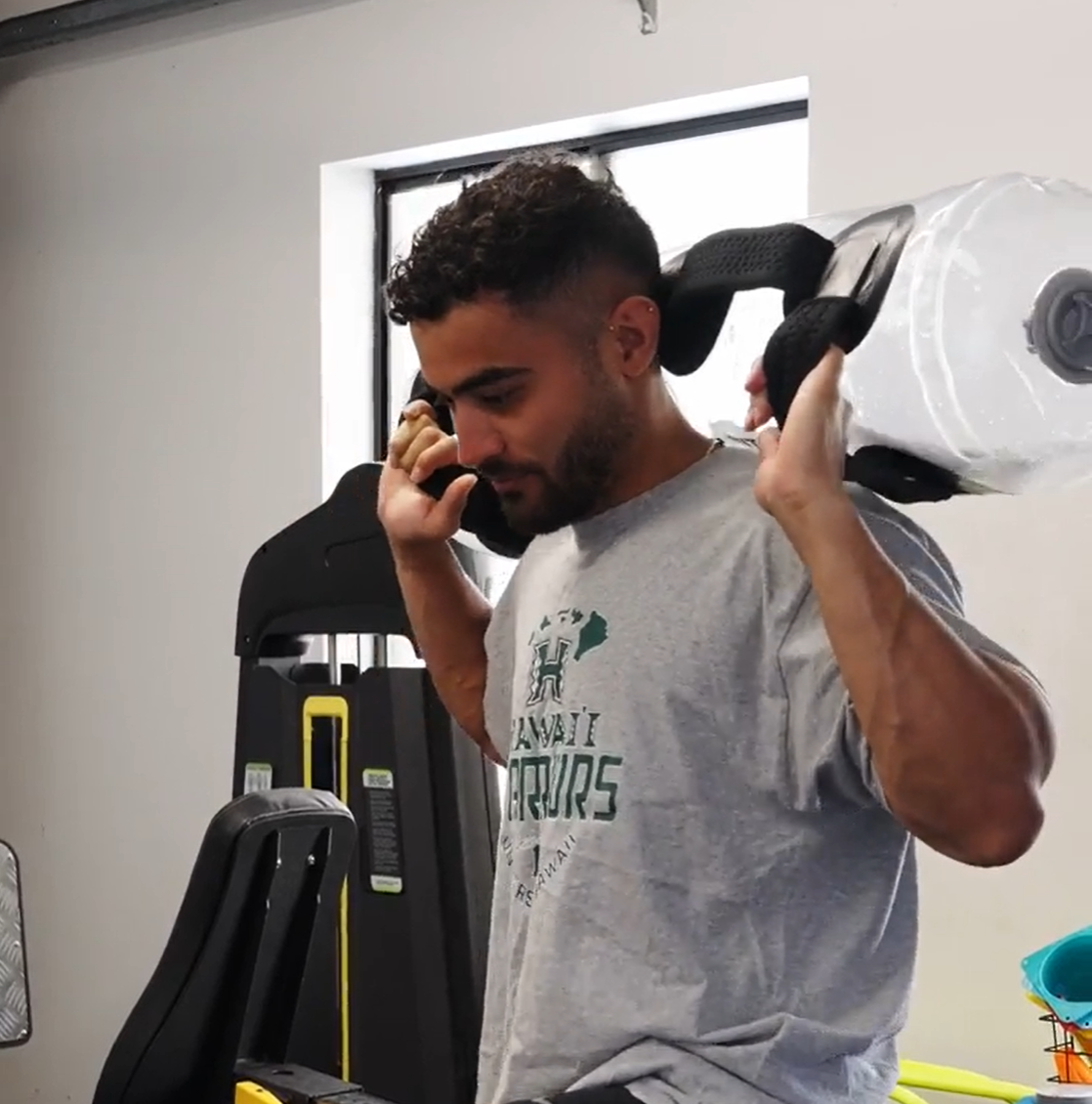 Physiotherapist demonstrating a water bag sport rehab exercise