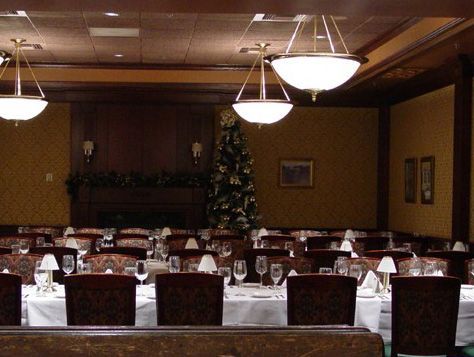 A restaurant with a christmas tree in the background