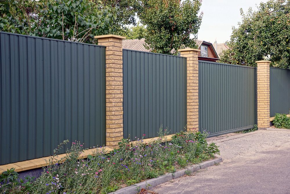 A Dark Green Corrugated Metal Fence — A Betta Fence 'N' Yard In Port Macquarie, NSW